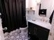 Elegant bathroom with a marble countertop vanity, modern fixtures, and stylish black and white accents at 10229 W Bolivar Dr, Sun City, AZ 85351
