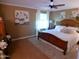 Spacious bedroom featuring a wooden bed frame, soft lighting, and neutral decor at 10229 W Bolivar Dr, Sun City, AZ 85351