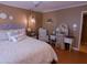 Bedroom with a cozy bed, bedside tables, soft lighting, vanity area, and elegant decor at 10229 W Bolivar Dr, Sun City, AZ 85351