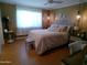 Cozy bedroom featuring a comfortable bed with decorative pillows, soft lighting, and stylish decor at 10229 W Bolivar Dr, Sun City, AZ 85351