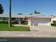 Charming single-story home with a two-car garage, complemented by a well-manicured lawn and mature landscaping at 10229 W Bolivar Dr, Sun City, AZ 85351