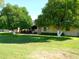 Beautiful home with a well-manicured lawn and mature orange trees, creating a charming curb appeal at 10229 W Bolivar Dr, Sun City, AZ 85351