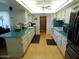 Spacious kitchen with bright lighting, full appliances, and white cabinets at 10229 W Bolivar Dr, Sun City, AZ 85351