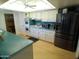 The kitchen has white cabinets, stainless steel appliances, and a light wood floor at 10229 W Bolivar Dr, Sun City, AZ 85351