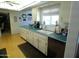 The bright kitchen features turquoise counters, white cabinets, and stainless steel appliances at 10229 W Bolivar Dr, Sun City, AZ 85351
