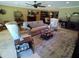 Bright living room featuring comfortable furnishings, a fireplace, and beautiful tile floors at 10229 W Bolivar Dr, Sun City, AZ 85351