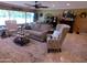 Bright living room featuring a ceiling fan, comfortable seating, and a view of the outdoors at 10229 W Bolivar Dr, Sun City, AZ 85351