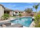 Inviting backyard with a sparkling pool, spa, covered patio, and lush landscaping for relaxation and entertainment at 10631 E Tallahassee Ave, Mesa, AZ 85212