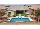 Beautiful backyard featuring a sparkling pool, spa, covered patio, and low-maintenance turf at 10631 E Tallahassee Ave, Mesa, AZ 85212