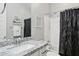 Well-lit bathroom features a granite countertop, decorative accents and a shower with modern fixtures at 10631 E Tallahassee Ave, Mesa, AZ 85212