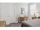 Well-lit bedroom featuring carpet, a writing desk, a nightstand, and a neutral color palette at 10631 E Tallahassee Ave, Mesa, AZ 85212