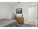Comfortable bedroom featuring carpet, TV, a wooden dresser, and a door leading to the en suite at 10631 E Tallahassee Ave, Mesa, AZ 85212