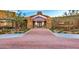 Elegant clubhouse entrance with stone accents and a beautifully landscaped walkway at 10631 E Tallahassee Ave, Mesa, AZ 85212