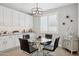Bright dining area next to the kitchen features modern lighting and dining table at 10631 E Tallahassee Ave, Mesa, AZ 85212
