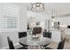 Open dining area with view of living room, featuring a glass table and modern decor at 10631 E Tallahassee Ave, Mesa, AZ 85212