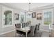 Elegant dining room with seating for six, plantation shutters, and modern chandelier at 10631 E Tallahassee Ave, Mesa, AZ 85212