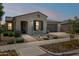 Inviting single-story home featuring a desert landscape, brick-paver walkway, and an attached two-car garage at 10631 E Tallahassee Ave, Mesa, AZ 85212