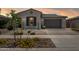 Charming single-story home featuring a well-maintained desert landscape, an attached two-car garage, and sidewalk access at 10631 E Tallahassee Ave, Mesa, AZ 85212