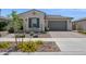 Inviting home showcasing a charming desert landscape and an attached two-car garage at 10631 E Tallahassee Ave, Mesa, AZ 85212