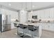 Modern kitchen features stainless steel appliances, white cabinets, and an island with bar stools at 10631 E Tallahassee Ave, Mesa, AZ 85212
