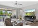 Open concept living room showcasing outdoor pool access, a modern fireplace, and a comfortable sofa at 10631 E Tallahassee Ave, Mesa, AZ 85212