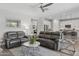 Bright open-concept living room with an adjacent kitchen and comfortable seating at 10631 E Tallahassee Ave, Mesa, AZ 85212
