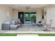 Outdoor patio featuring stylish seating, a ceiling fan, lighting, and serene views of the backyard pool at 10631 E Tallahassee Ave, Mesa, AZ 85212