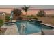 Backyard pool featuring a waterfall, nice landscaping, and desert sunset at 10631 E Tallahassee Ave, Mesa, AZ 85212