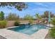 Private pool with a waterfall feature, lounge chairs, and beautiful landscaping for outdoor enjoyment at 10631 E Tallahassee Ave, Mesa, AZ 85212