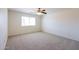 Cozy bedroom with neutral carpet, ceiling fan, and a window for natural light at 11357 W Buchanan St, Avondale, AZ 85323