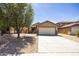 Charming home featuring a well-kept lawn, stone accents, and a two-car garage at 11357 W Buchanan St, Avondale, AZ 85323