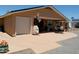 Back exterior showing covered patio area with desert landscaping and hardscape at 11415 N 110Th Dr, Sun City, AZ 85351
