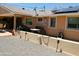 A backyard patio area with gravel landscaping, solar panels, and covered seating is perfect for outdoor relaxation at 11415 N 110Th Dr, Sun City, AZ 85351