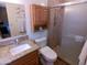 Bathroom with granite countertop vanity, toilet, and tiled shower enclosure at 11415 N 110Th Dr, Sun City, AZ 85351