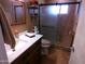 Bathroom features a modern vanity, stylish mirror, and a glass-enclosed shower at 11415 N 110Th Dr, Sun City, AZ 85351