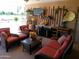 Inviting covered patio with comfortable seating, TV and decor for relaxing outdoor entertainment at 11415 N 110Th Dr, Sun City, AZ 85351