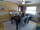 Dining area featuring a black table, seating for six, and natural light from the large window at 11415 N 110Th Dr, Sun City, AZ 85351