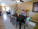 A bright dining room with modern furniture, natural light, and an adjacent living space at 11415 N 110Th Dr, Sun City, AZ 85351