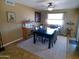 Dining area with a modern table, seating for six, and natural light from the large window at 11415 N 110Th Dr, Sun City, AZ 85351