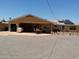 A spacious home exterior with desert landscaping featuring a covered patio for relaxed, outdoor living at 11415 N 110Th Dr, Sun City, AZ 85351