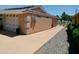 Exterior view of the house and garage features neutral colors and mature landscaping at 11415 N 110Th Dr, Sun City, AZ 85351