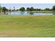 Lush green golf course with tranquil lake and mature trees offers a serene outdoor recreational experience at 11415 N 110Th Dr, Sun City, AZ 85351