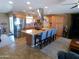 Spacious kitchen with stainless steel appliances, tile floors, and an island with seating and cooktop at 11415 N 110Th Dr, Sun City, AZ 85351