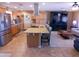 Open concept kitchen with stainless appliances, granite counters, and a large island with seating at 11415 N 110Th Dr, Sun City, AZ 85351