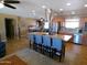 Bright kitchen with stainless steel appliances, a large island, and views to the dining area at 11415 N 110Th Dr, Sun City, AZ 85351