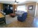 A spacious, open-concept living room with a tile floor provides ample room for seating and entertaining at 11415 N 110Th Dr, Sun City, AZ 85351