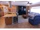 An open-concept living area featuring hardwood floors, ample lighting, and modern furnishings at 11415 N 110Th Dr, Sun City, AZ 85351