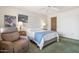 Comfortable bedroom featuring plush carpeting, a ceiling fan, and ample natural light through the window at 12542 W Parkwood Dr, Sun City West, AZ 85375