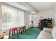 Bonus room features green carpet, bright light, and office space at 12542 W Parkwood Dr, Sun City West, AZ 85375