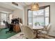 Bright breakfast nook featuring a bay window, decorative pendant light, and adjacent desk space for added functionality at 12542 W Parkwood Dr, Sun City West, AZ 85375